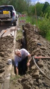 West Omaha Irrigation digging a trench for sprinkler system lines
